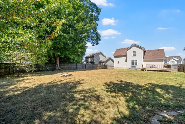 a view of a house with a yard and garage