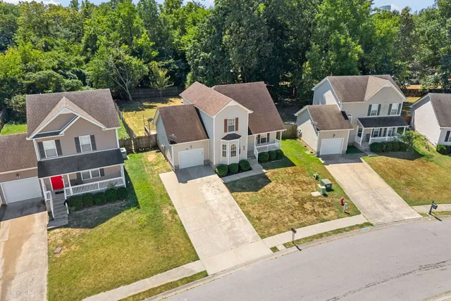 an aerial view of a house with swimming pool and porch