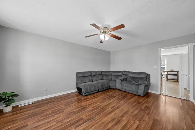a living room with hard wood floors and a couch