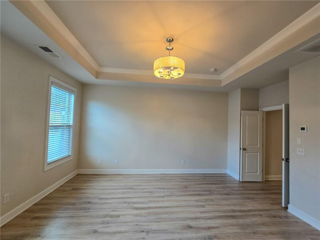 1758 Glenview Park Circle Duluth, GA 30097 - Photo 19 of 45 wooden floor in an empty room with a window