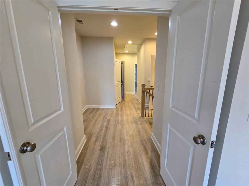 1758 Glenview Park Circle Duluth, GA 30097 - Photo 20 of 45 a view of a hallway with wooden floor and staircase