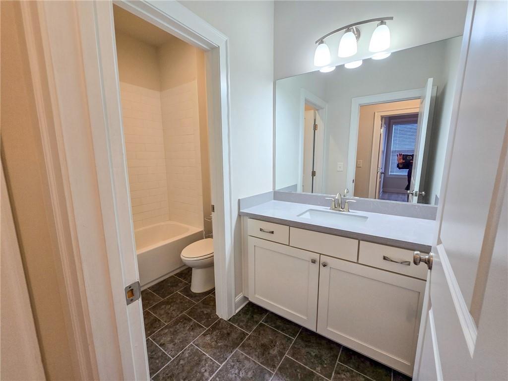 1758 Glenview Park Circle Duluth, GA 30097 - Photo 24 of 45 a bathroom with a granite countertop sink a toilet and a mirror