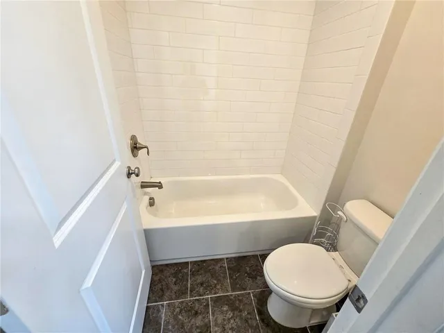 a bathroom with a toilet and a bathtub