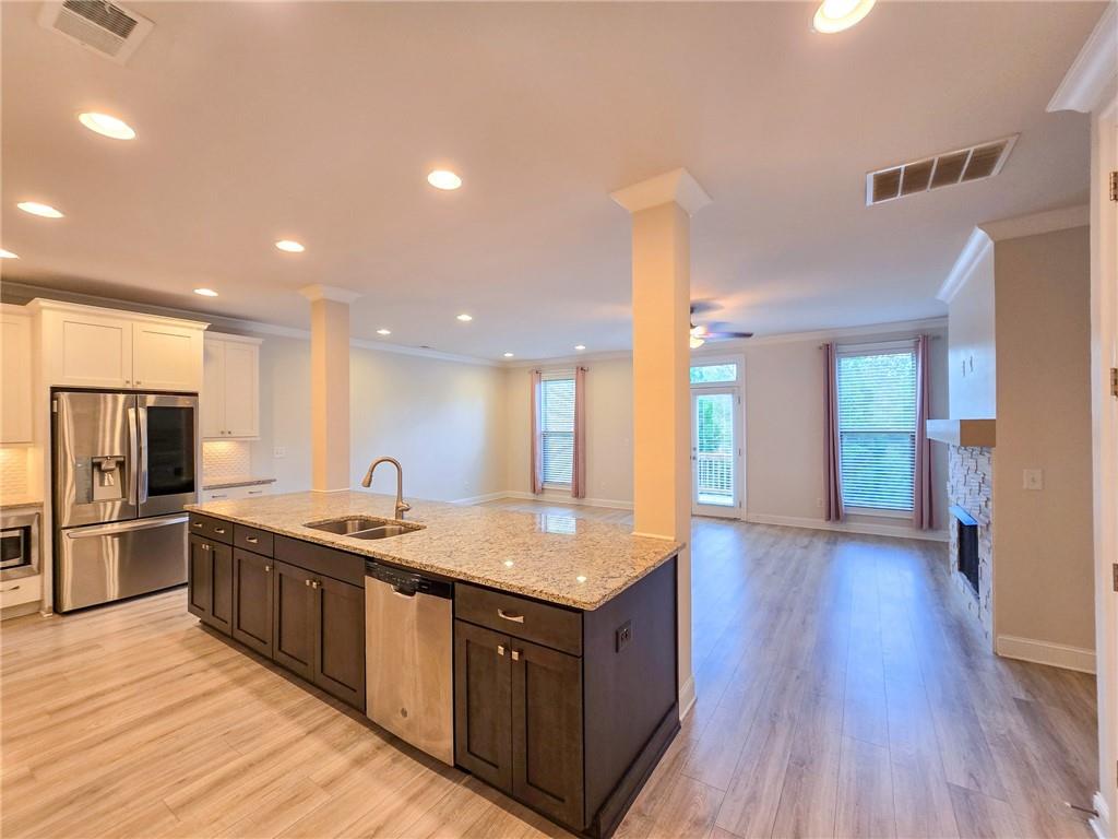1758 Glenview Park Circle Duluth, GA 30097 - Photo 31 of 45 a kitchen with stainless steel appliances granite countertop a sink stove and refrigerator