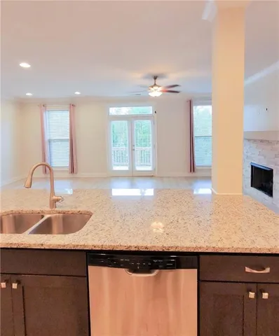 a kitchen with a sink refrigerator and cabinets