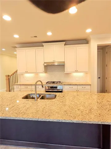 a kitchen with a sink cabinets and window