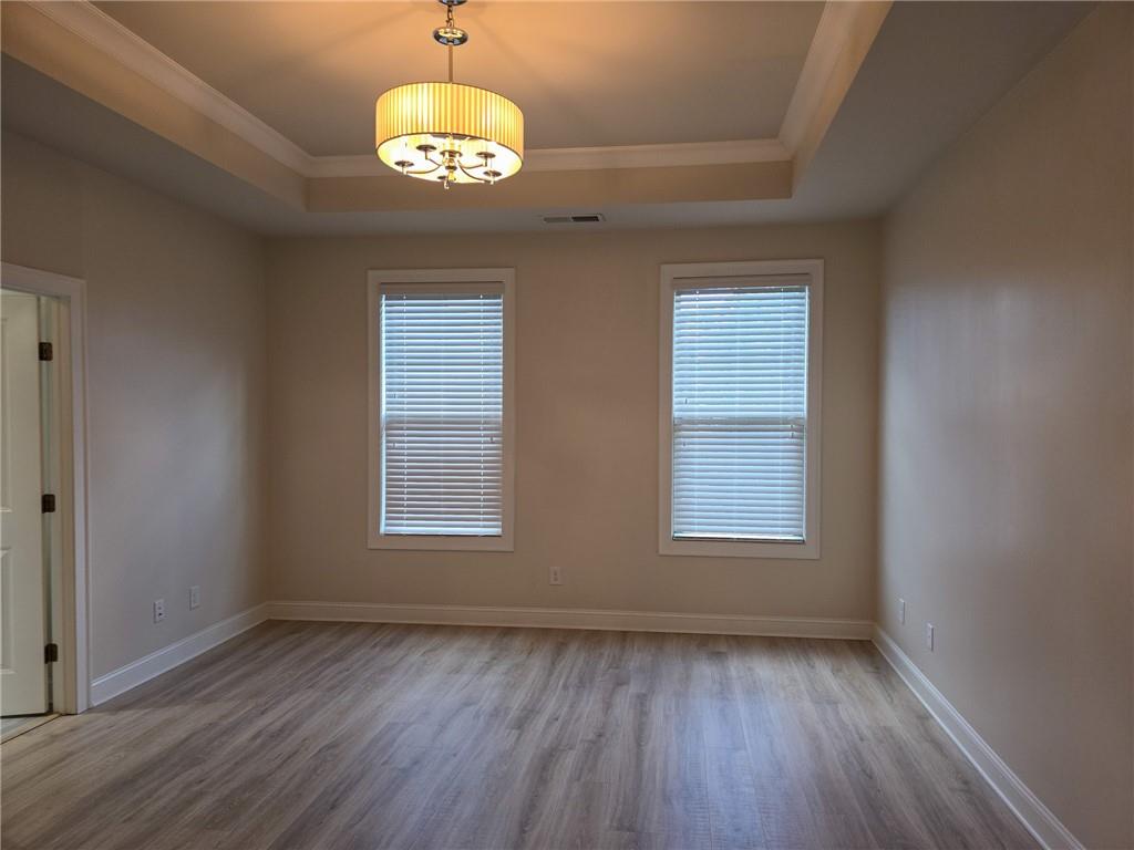 1758 Glenview Park Circle Duluth, GA 30097 - Photo 6 of 45 an empty room with wooden floor and windows