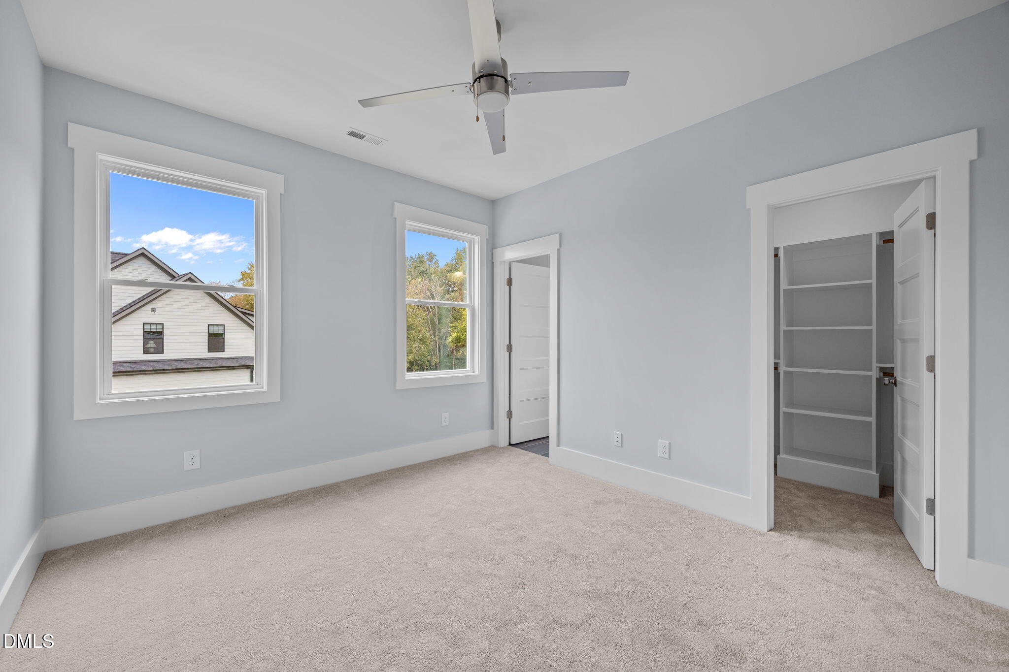 10 Carnation Road Youngsville, NC 27596 - Photo 27 of 44 an empty room with windows and a ceiling fan