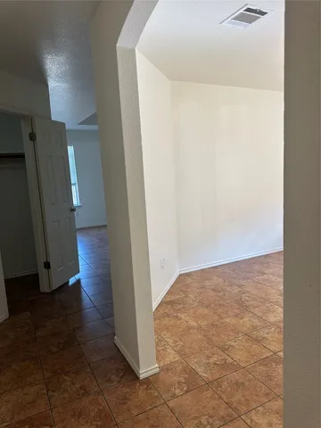 an empty room with wooden floor