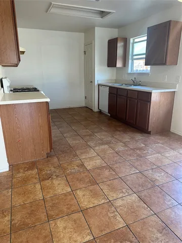 a room with a sink a stove a mirror and vanity