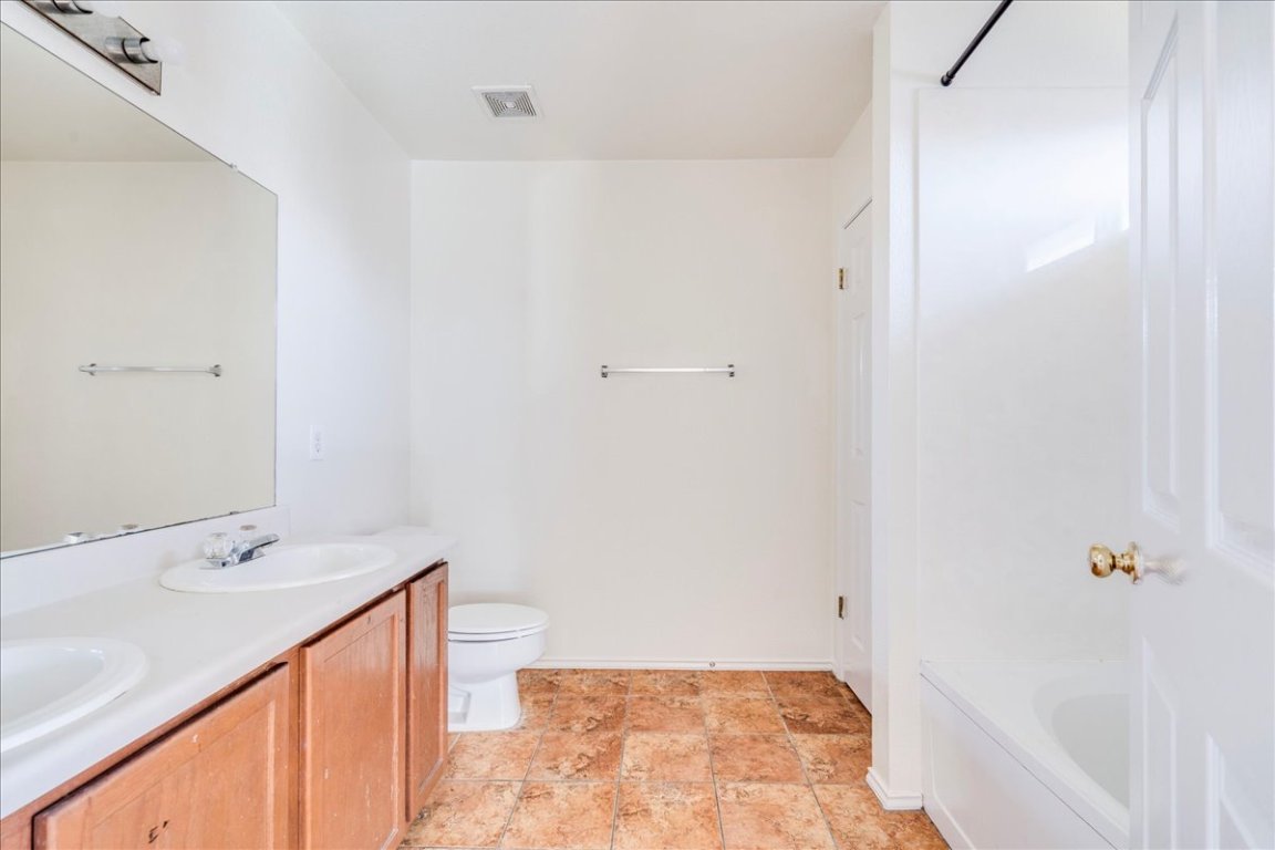 116 Keegans Way Kyle, TX 78640 - Photo 18 of 30 a bathroom with a sink and a mirror