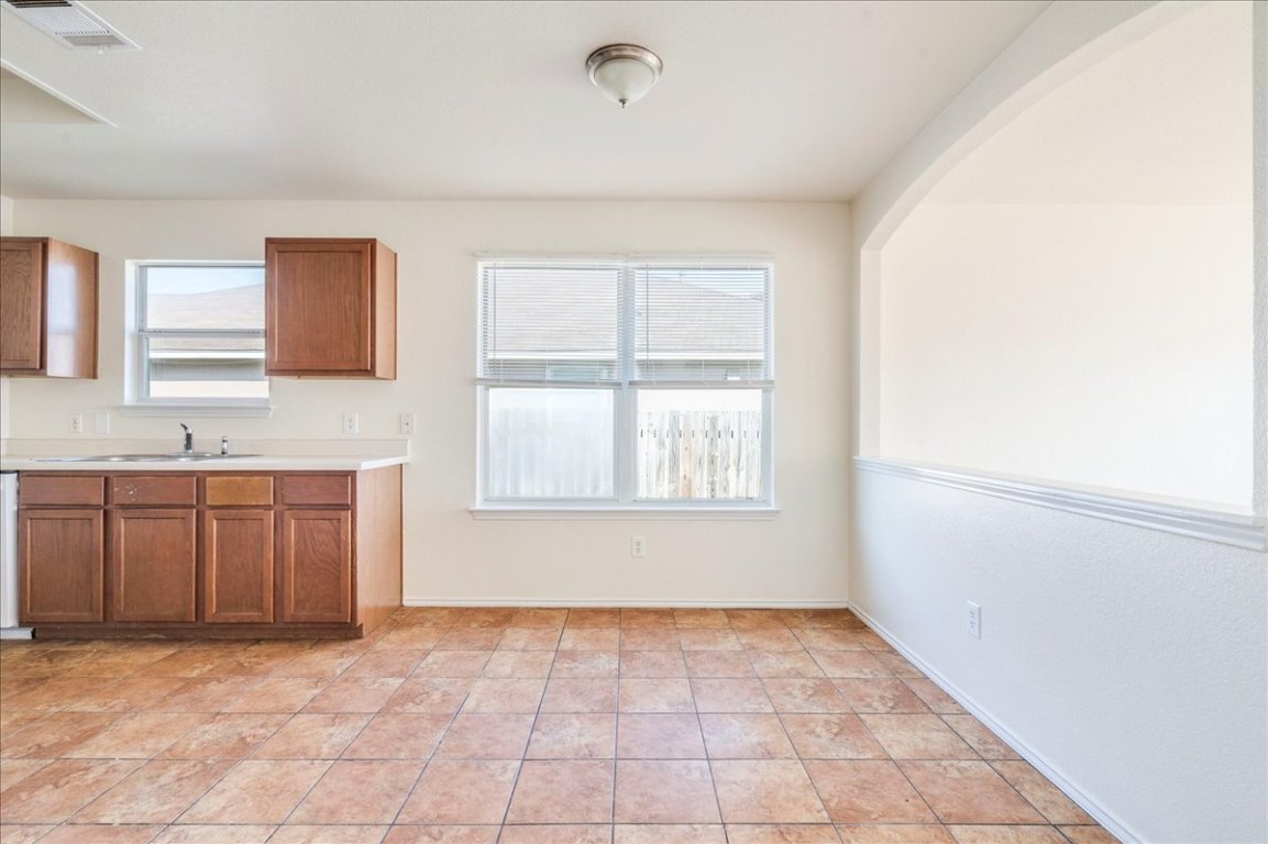 116 Keegans Way Kyle, TX 78640 - Photo 10 of 30 a view of a kitchen with a sink and a window