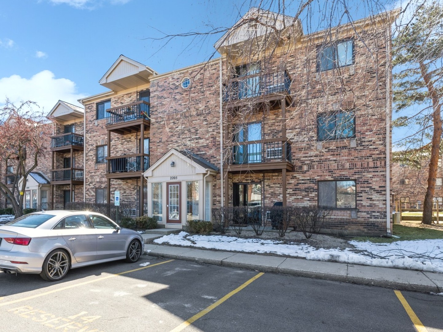 a car parked in front of a brick house