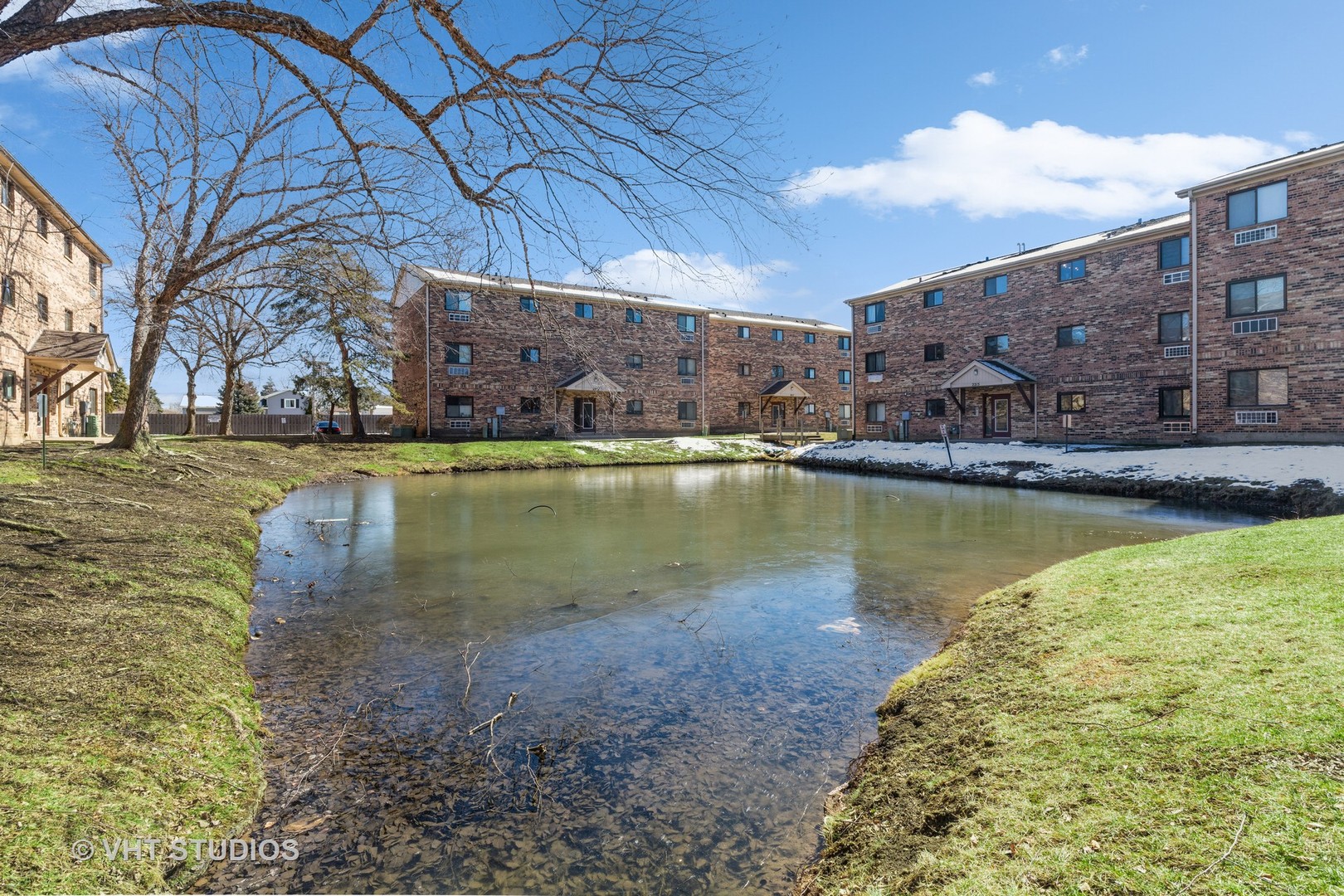 2205 West Nichols Road, Unit F Arlington Heights, IL 60004 - Photo 14 of 15 a view of a lake with a building in the background