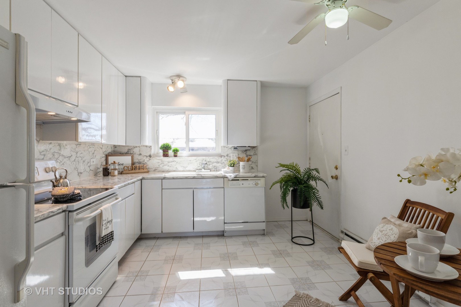 2205 West Nichols Road, Unit F Arlington Heights, IL 60004 - Photo 5 of 15 a kitchen with a white cabinets and window