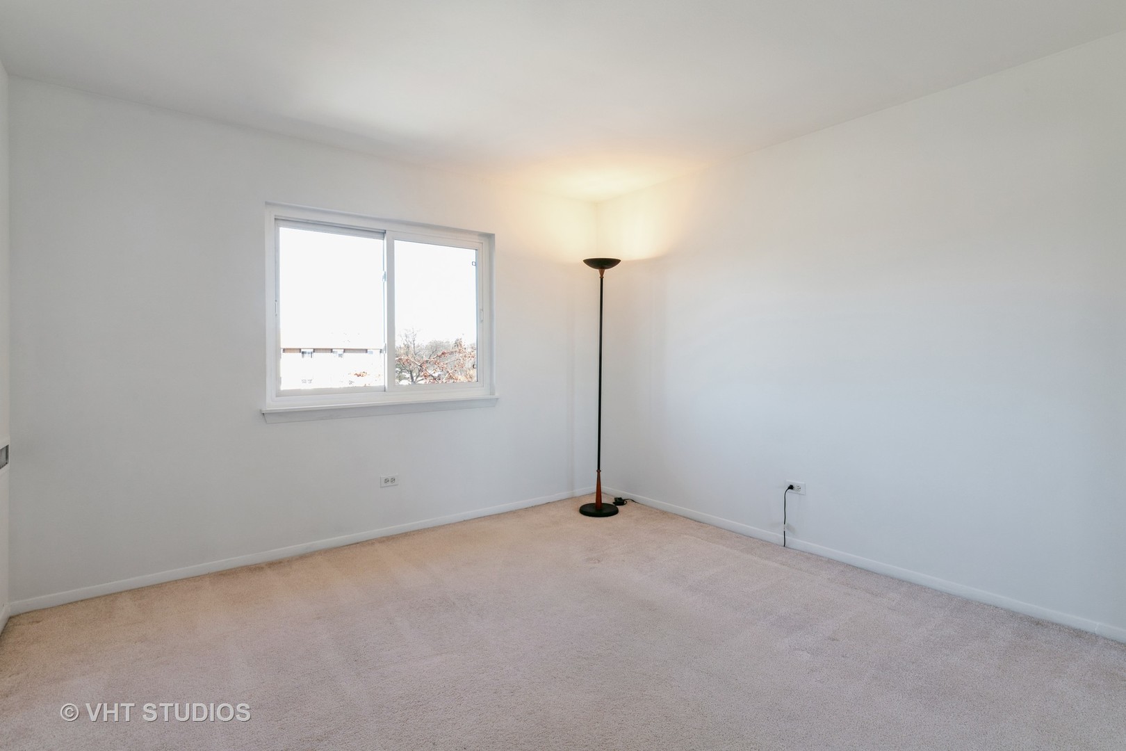 2205 West Nichols Road, Unit F Arlington Heights, IL 60004 - Photo 10 of 15 an empty room with windows