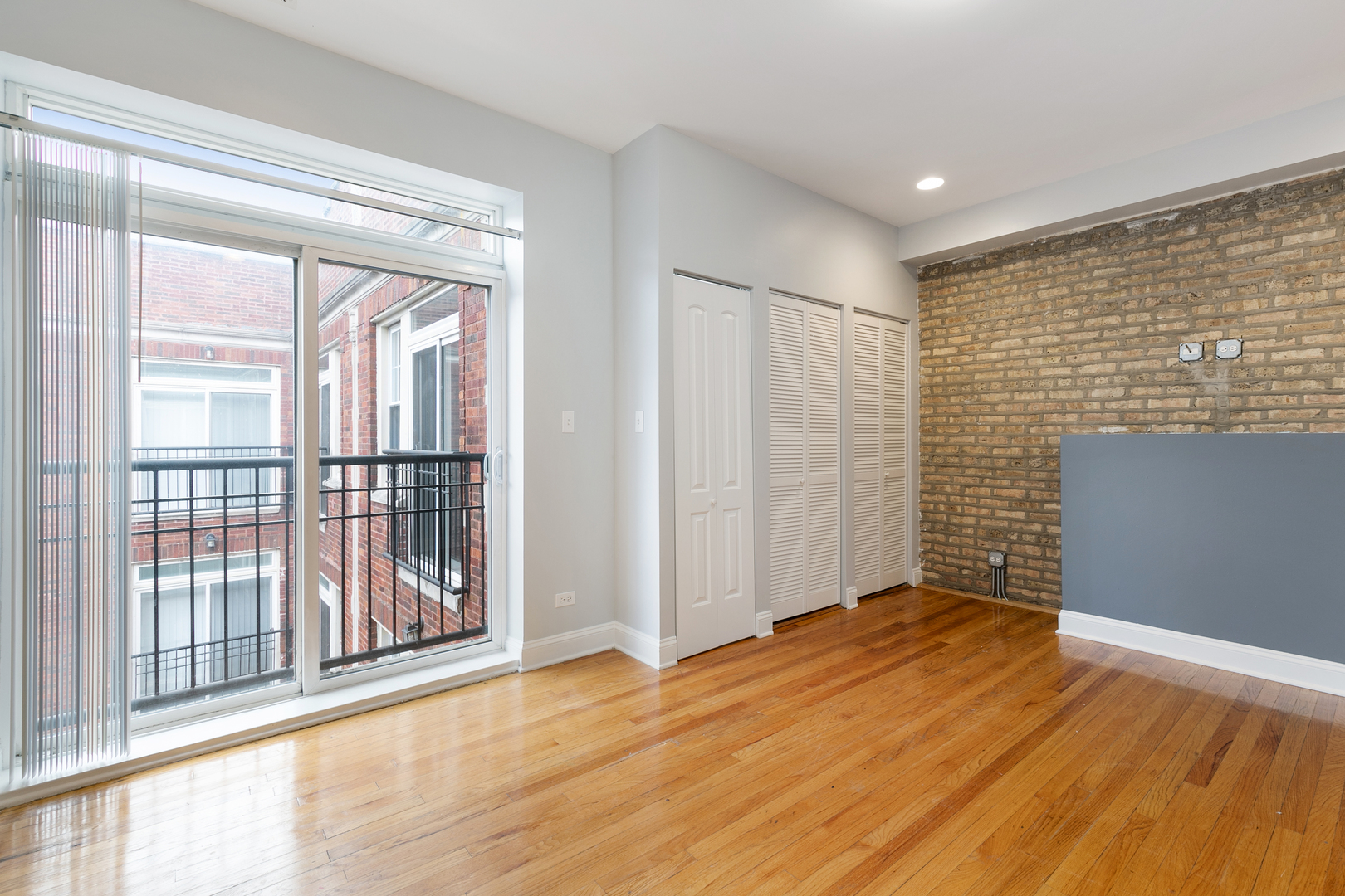 2011 West Jarvis Avenue, Unit 3 Chicago, IL 60645 - Photo 2 of 15 a view of an empty room with wooden floor and a window