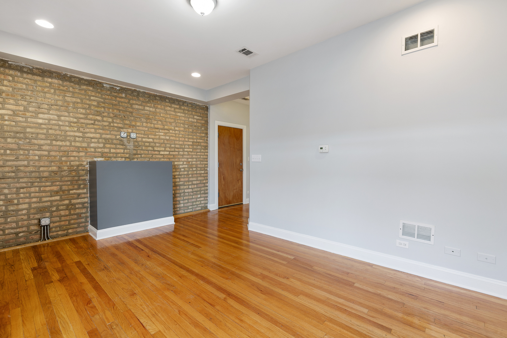 2011 West Jarvis Avenue, Unit 3 Chicago, IL 60645 - Photo 3 of 15 a view of an empty room with wooden floor