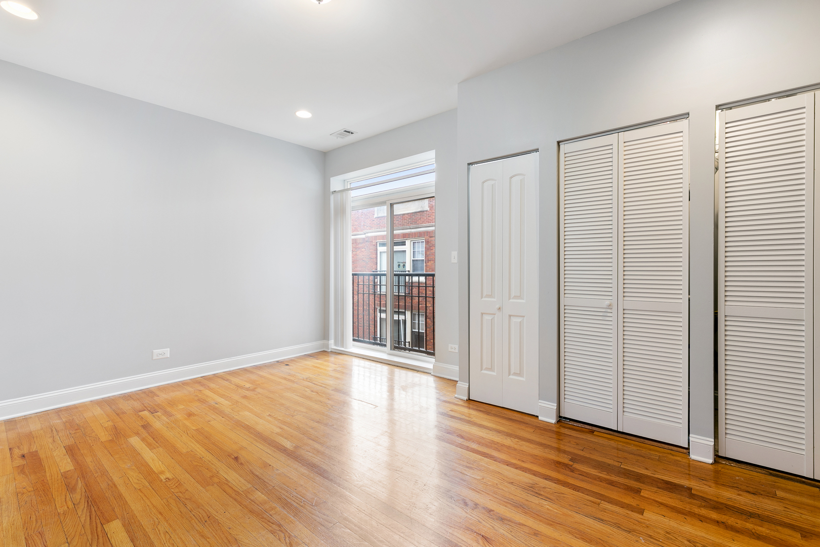 2011 West Jarvis Avenue, Unit 3 Chicago, IL 60645 - Photo 6 of 15 wooden floor in an empty room with a window