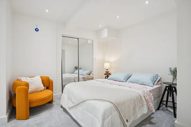 a bedroom with bed and blue couch