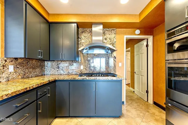 a view of a kitchen with granite countertop a sink and a stove