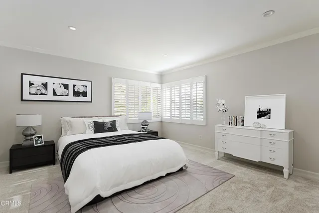 a spacious bedroom with a bed and window