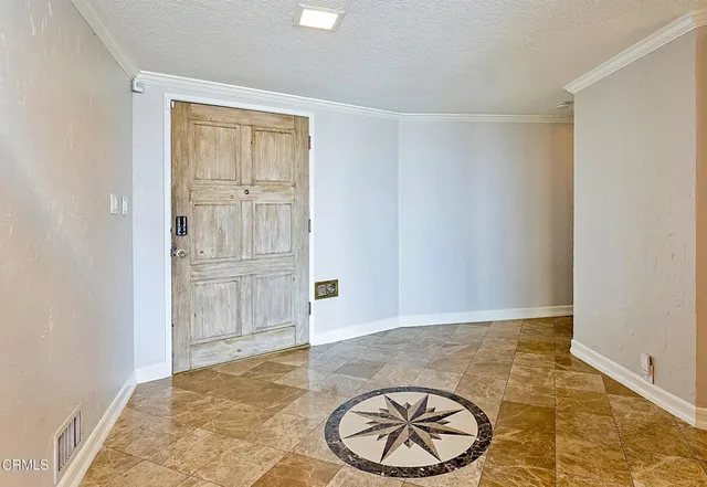 an empty room with cabinet and mirror