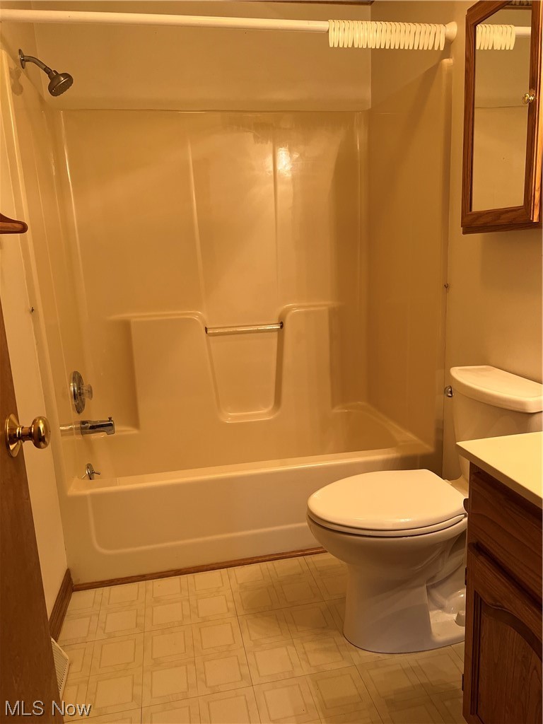 9066 Crow Road Litchfield, OH 44253 - Photo 28 of 28 Full bathroom with toilet, tile floors, bathing tub / shower combination, and vanity