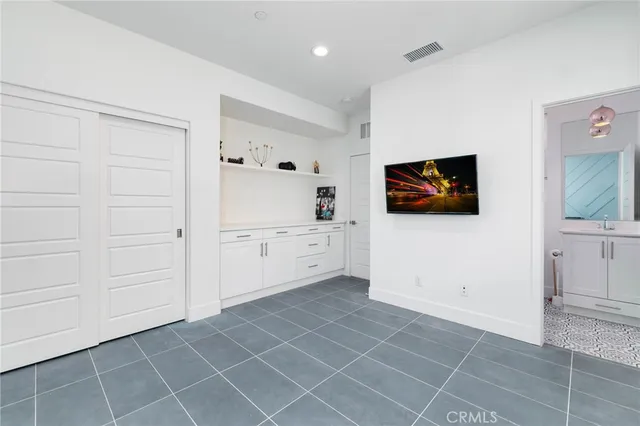 a view of a kitchen with white cabinets