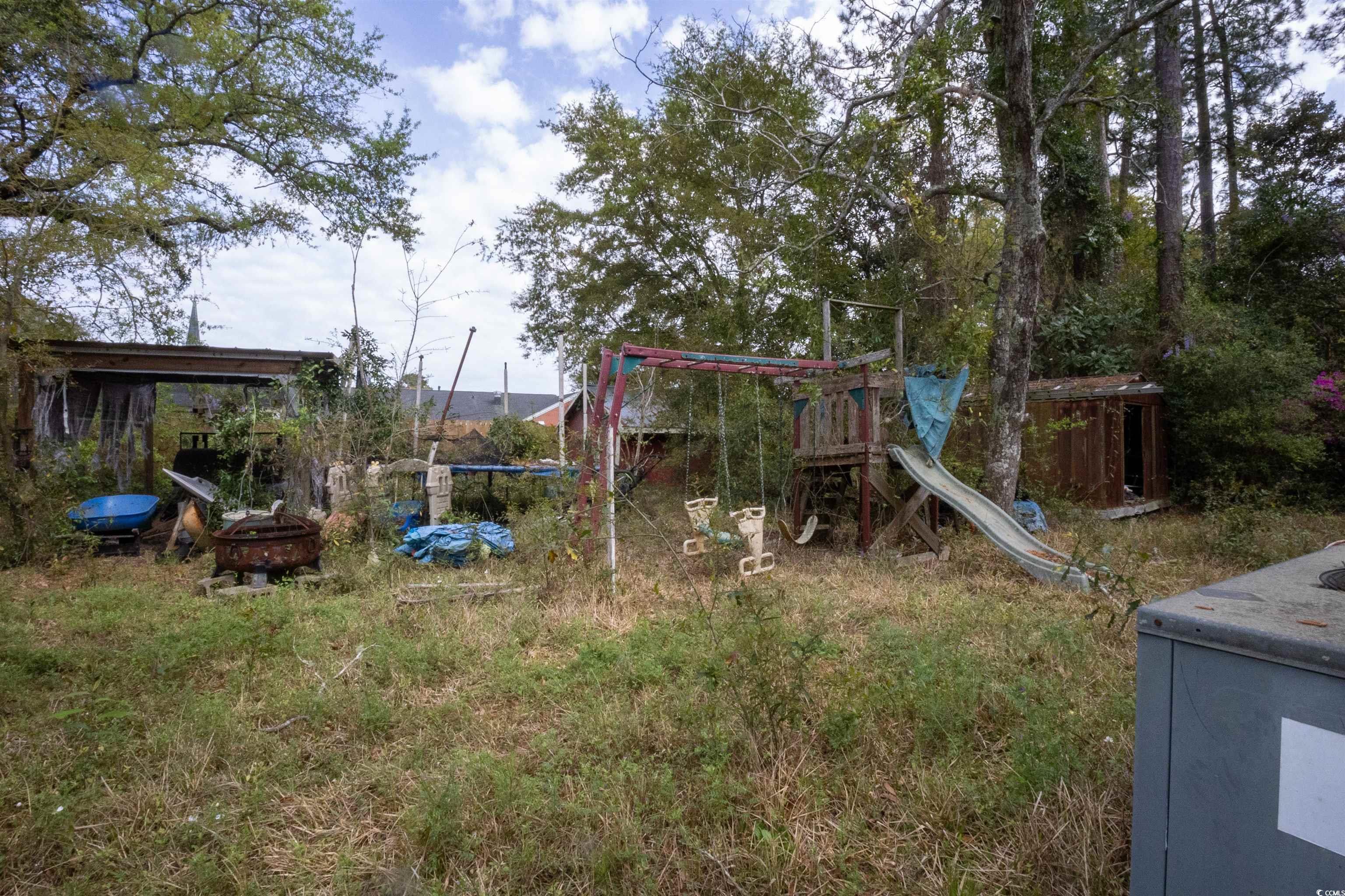 2405 South Island Road Georgetown, SC 29440 - Photo 21 of 24 View of playground with an outdoor fire pit and a trampoline