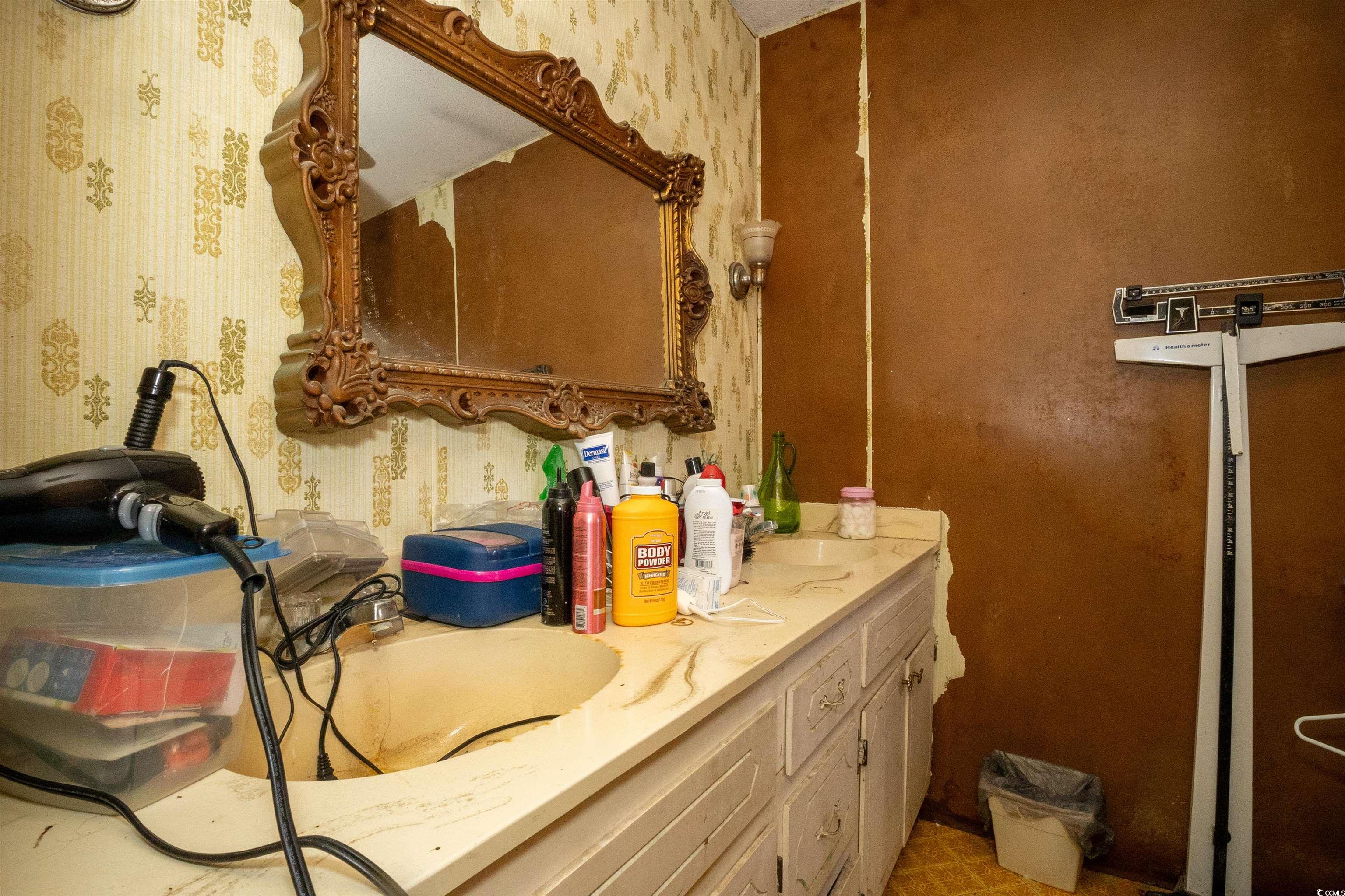 2405 South Island Road Georgetown, SC 29440 - Photo 6 of 24 Bathroom with wallpapered walls, a sink, and double vanity
