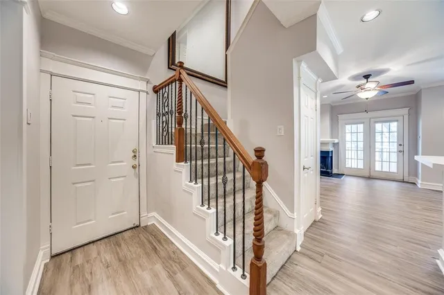 a view of a hallway with wooden floor and staircase