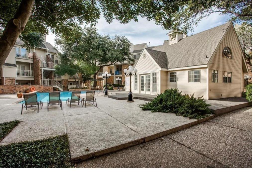 5325 Bent Tree Forest Drive, Unit 2244 Dallas, TX 75248 - Photo 14 of 15 a view of a white house with a patio table and chairs