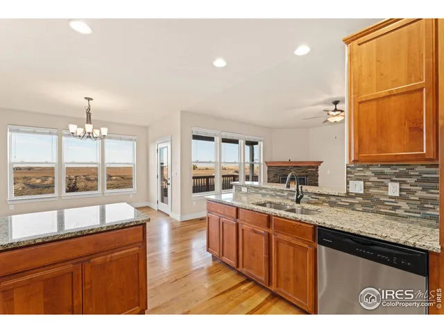 a large kitchen with kitchen island granite countertop a large window