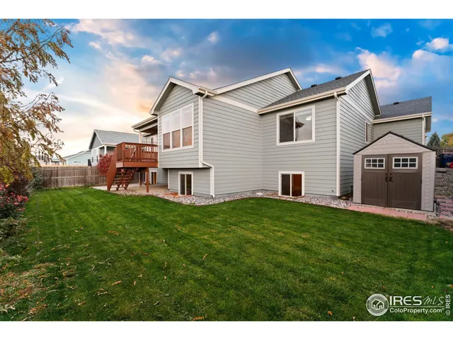 a view of a house with a yard and sitting area