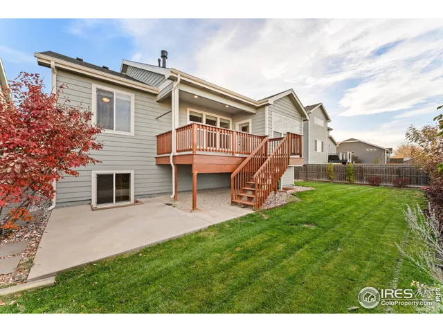 a view of a house with a backyard and a patio