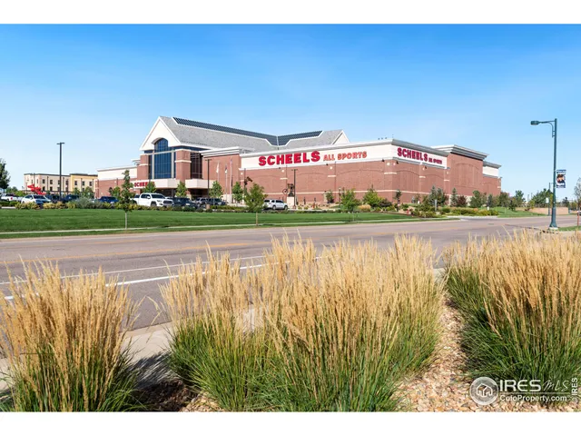 a view of a lake with a big yard and large trees