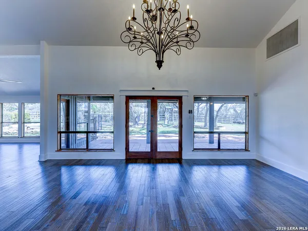 a view of room with wooden floor and fan