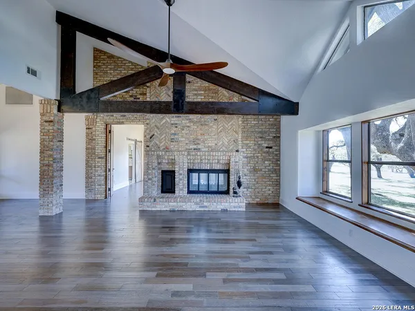 a kitchen with granite countertop white cabinets and stainless steel appliances