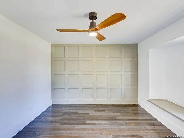 wooden floor fireplace and windows in an empty room
