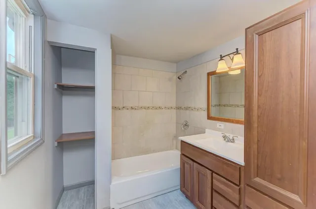 a bathroom with a bathtub and a shower