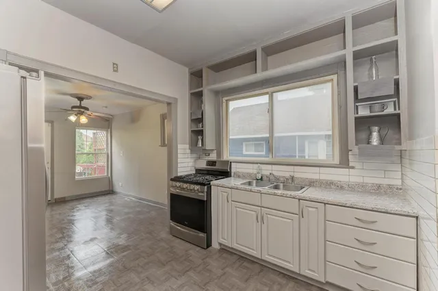 a kitchen with stainless steel appliances granite countertop a stove and a sink