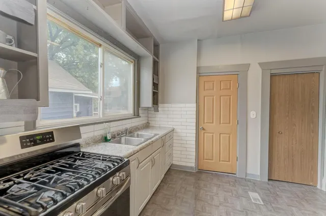 a kitchen that has a sink and a stove