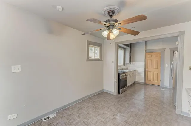 a view of a kitchen with a sink and a refrigerator