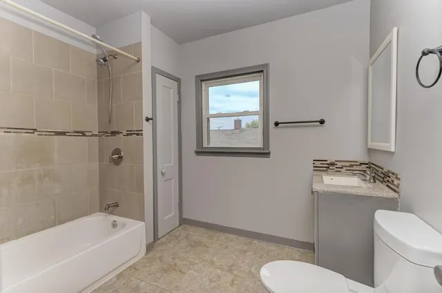 a bathroom with a toilet sink and shower