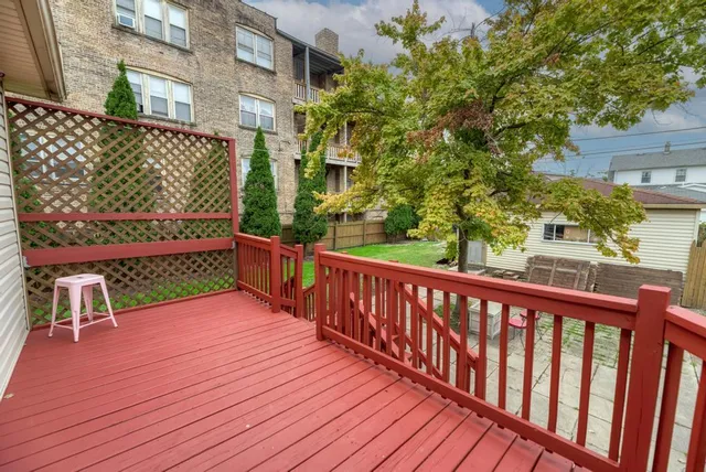 a view of a deck with wooden floor and fence