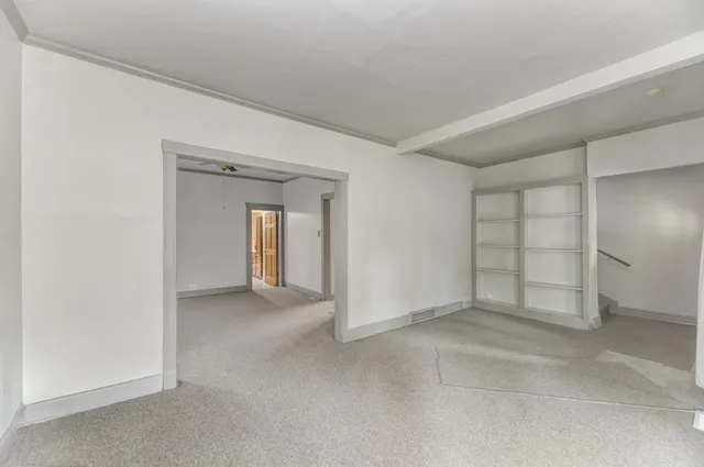 a view of an empty room and closet area