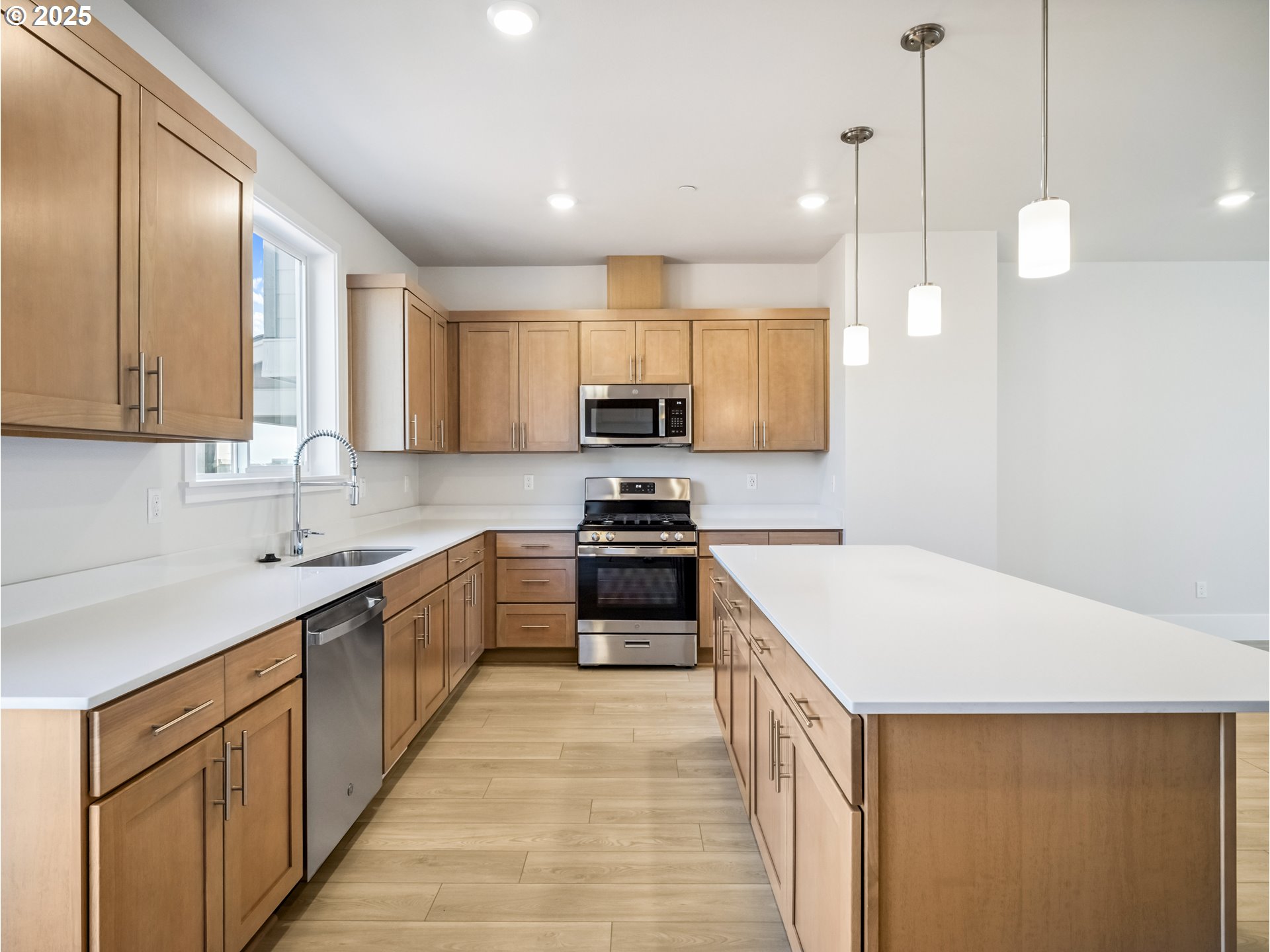 11950 Southwest 176th Drive Beaverton, OR 97007 - Photo 16 of 20 a kitchen with a sink a stove and cabinets