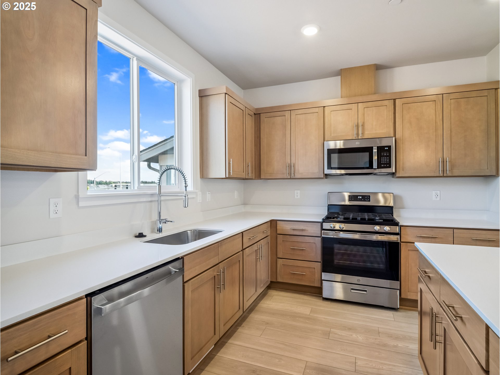 11950 Southwest 176th Drive Beaverton, OR 97007 - Photo 17 of 20 a kitchen with stainless steel appliances granite countertop a sink stove and microwave