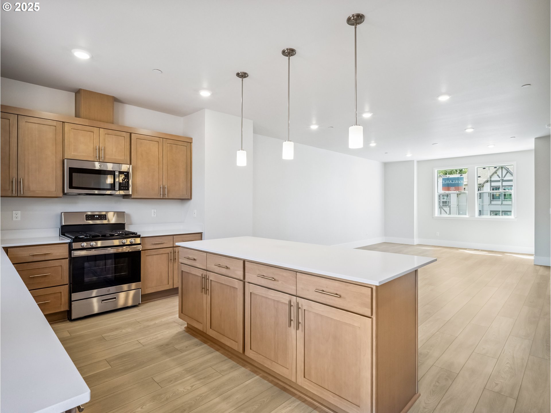 11950 Southwest 176th Drive Beaverton, OR 97007 - Photo 18 of 20 a kitchen with stainless steel appliances granite countertop a sink a stove a refrigerator and white cabinets with wooden floor